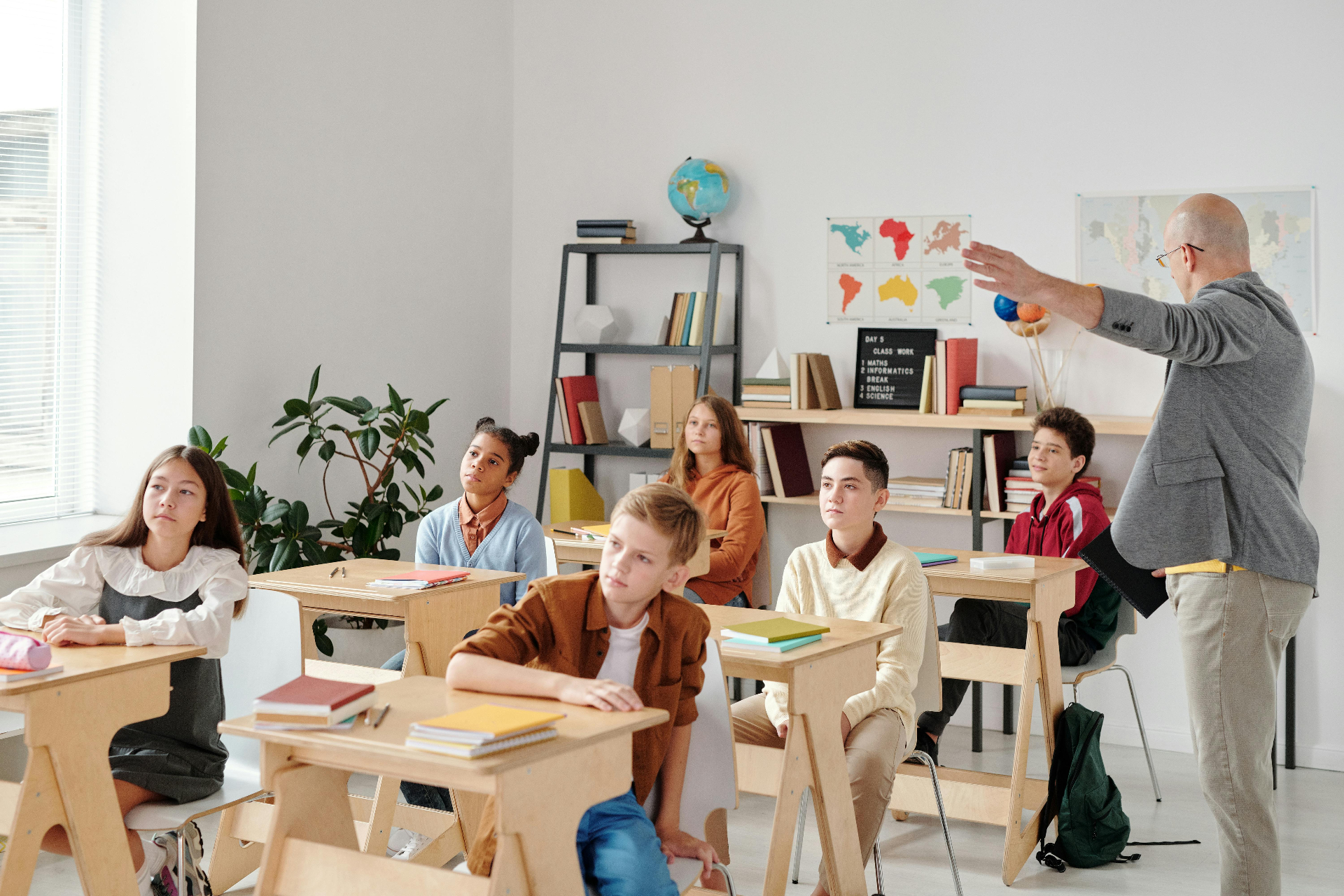 معلمة تساعد طلاب صغار